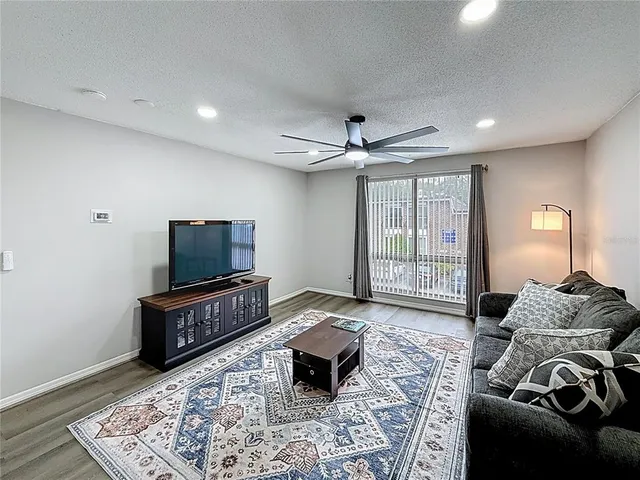 a bedroom with furniture and a flat screen tv