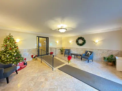 a view of a room with gym equipment and potted plants