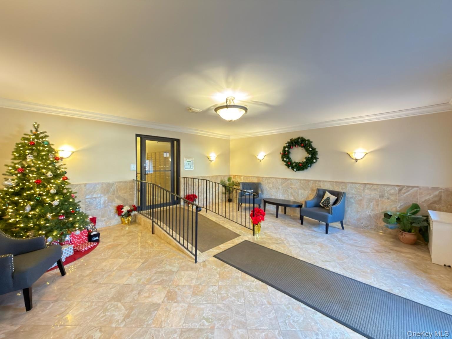 42 Barker Avenue, Unit 2B White Plains, NY 10601 - Photo 11 of 13 Building lobby with wainscoting, ornamental molding, and tile walls