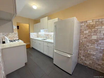 a kitchen with a refrigerator sink and stove