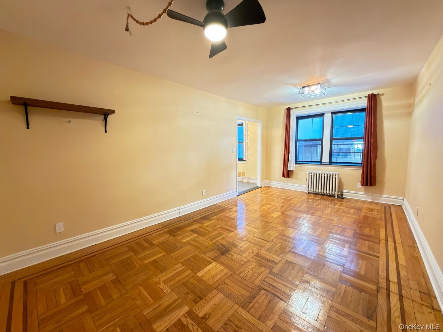 42 Barker Avenue, Unit 2B White Plains, NY 10601 - Photo 5 of 13 Spare room with a ceiling fan and radiator