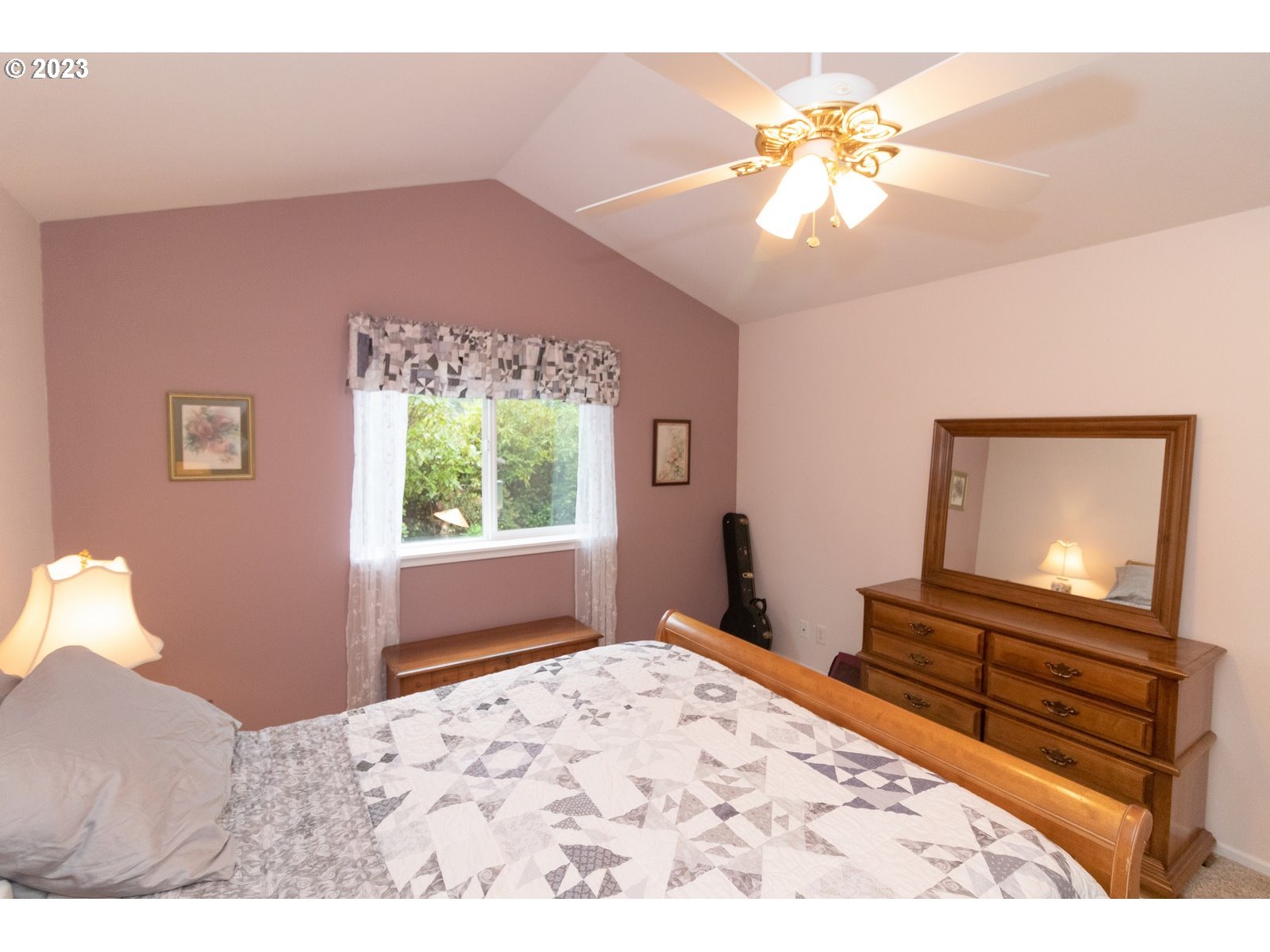 18 Mariners Lane Florence, OR 97439 - Photo 16 of 28 a bedroom with a bed and a flat screen tv with dresser