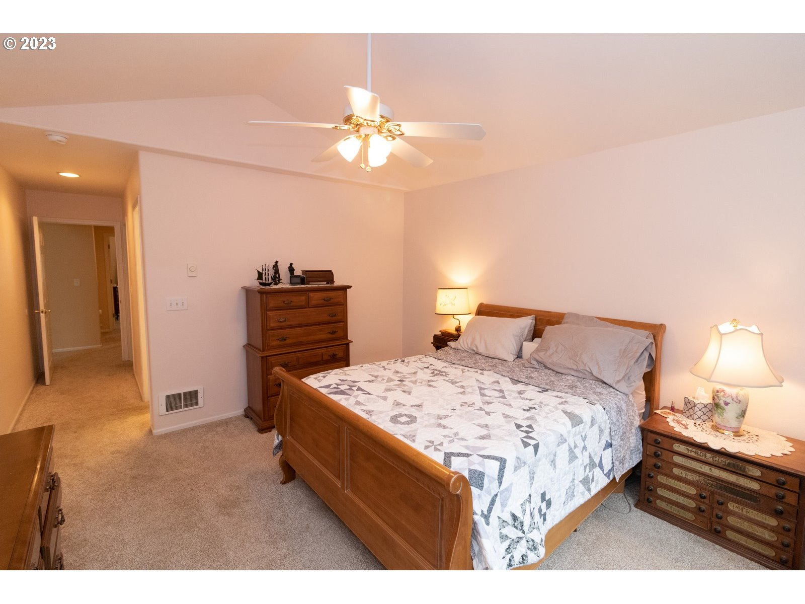 18 Mariners Lane Florence, OR 97439 - Photo 17 of 28 a bedroom with a bed and a chandelier