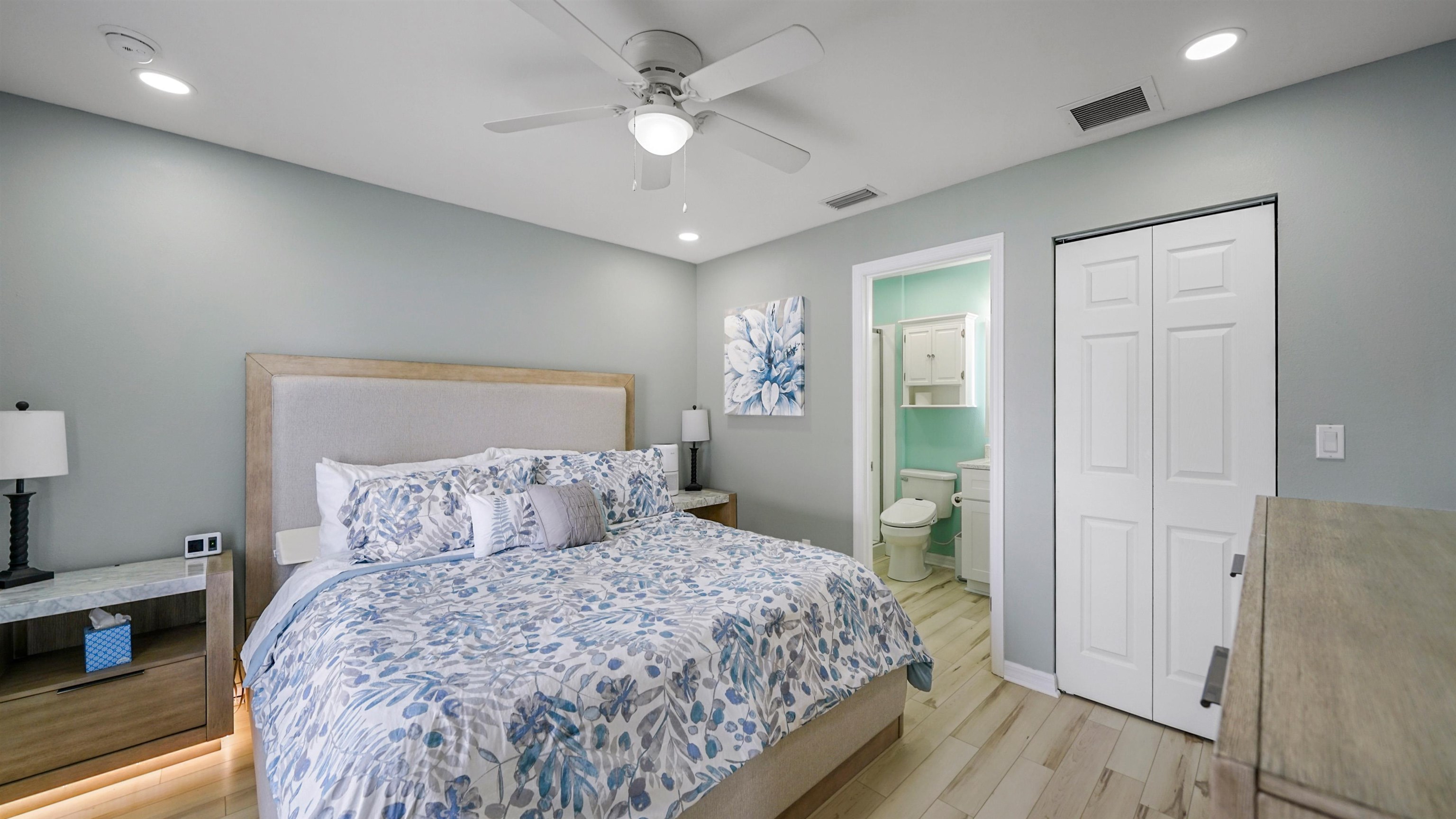 321 West Jayce Way St. Augustine, FL 32084 - Photo 14 of 34 a bedroom with a large bed and a chandelier