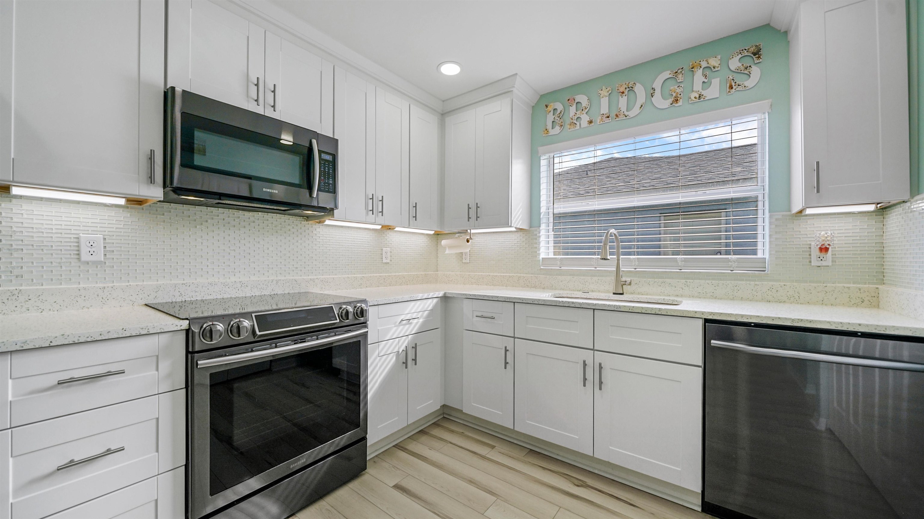 321 West Jayce Way St. Augustine, FL 32084 - Photo 3 of 34 a kitchen with stainless steel appliances a stove microwave and sink