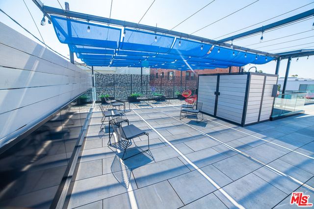 a terrace with outdoor seating and city view