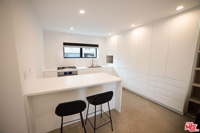 a kitchen with a stove and a white cabinet