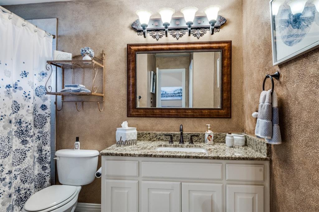 2810 Baker Street Sachse, TX 75048 - Photo 23 of 26 Full bathroom with vanity, a shower with curtain, and a textured wall