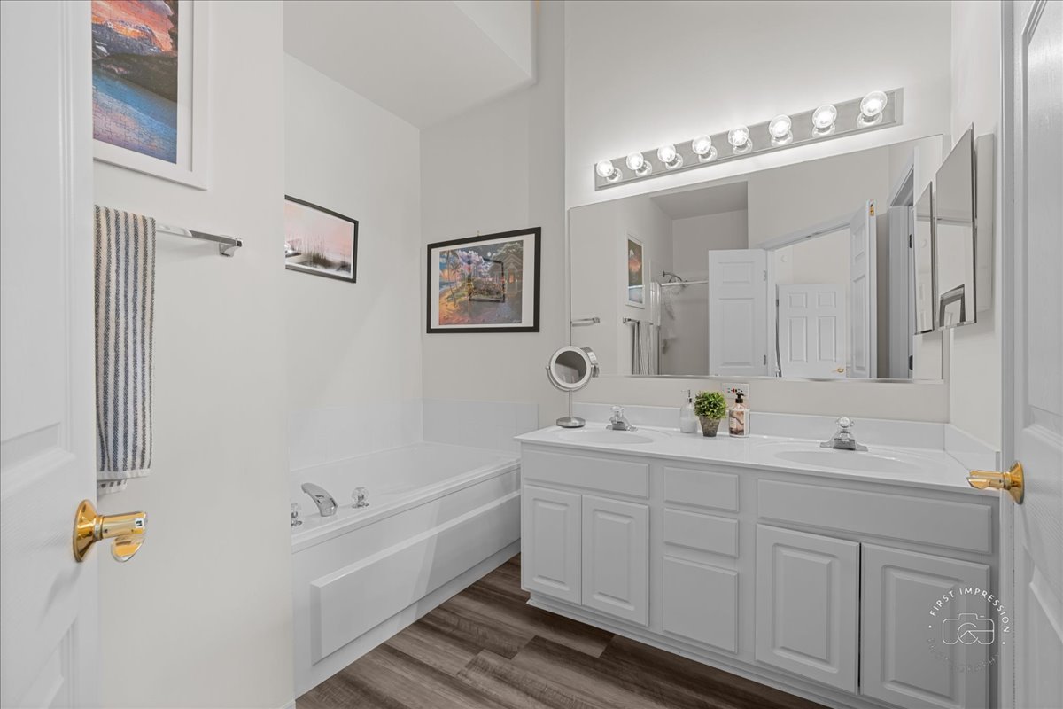 263 Lillian Court Geneva, IL 60134 - Photo 14 of 27 a spacious bathroom with a double vanity sink a large mirror and a bathtub