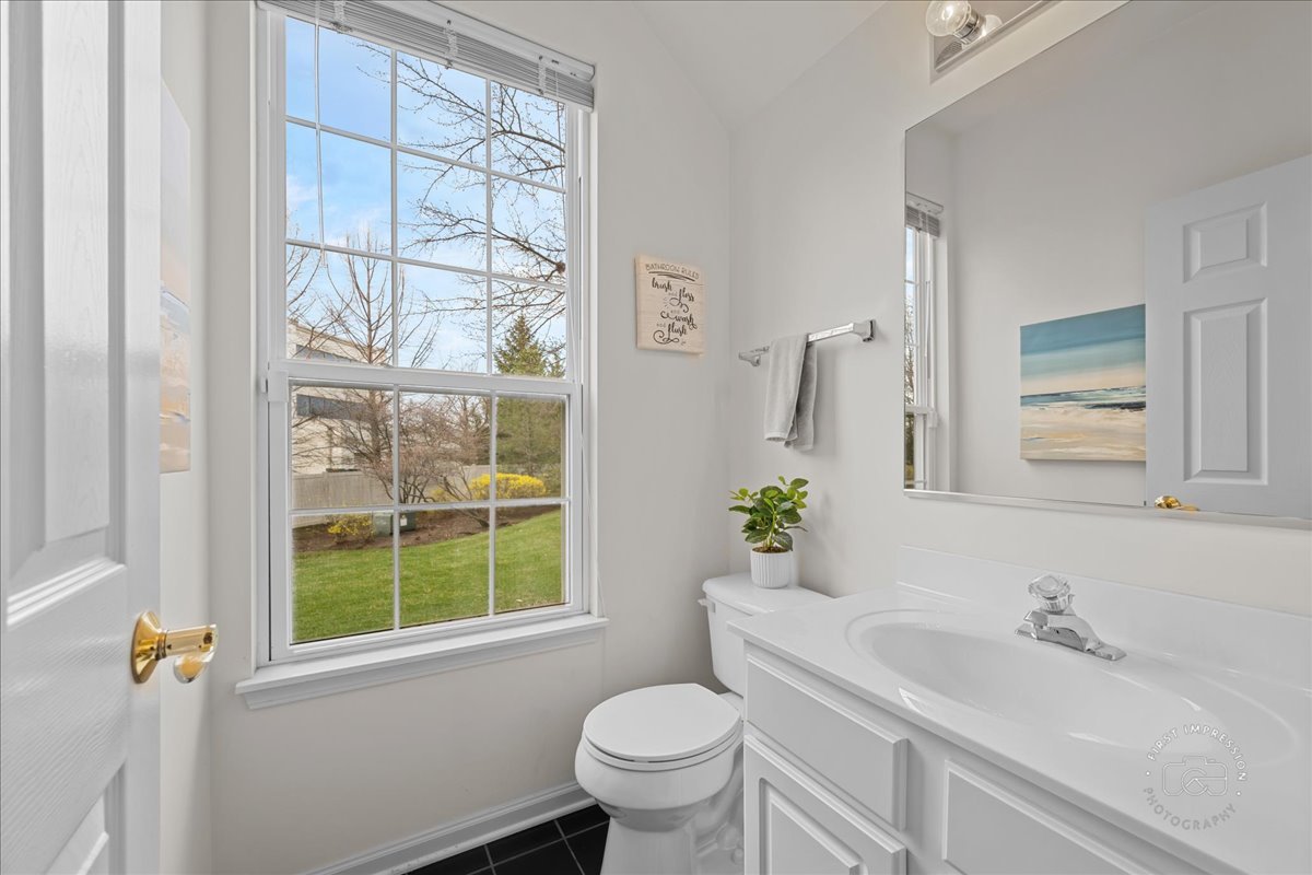 263 Lillian Court Geneva, IL 60134 - Photo 16 of 27 a bathroom with a toilet sink and mirror