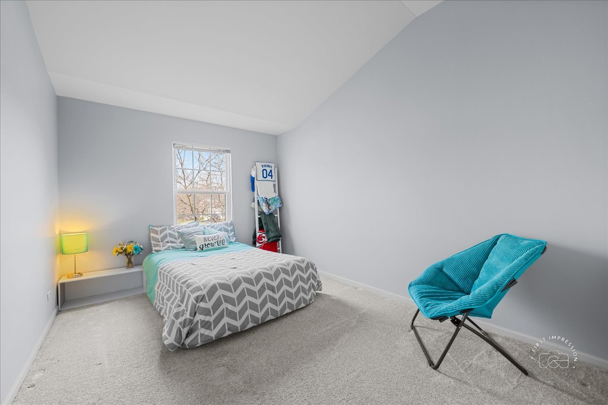 263 Lillian Court Geneva, IL 60134 - Photo 18 of 27 a bedroom with a bed and a chair