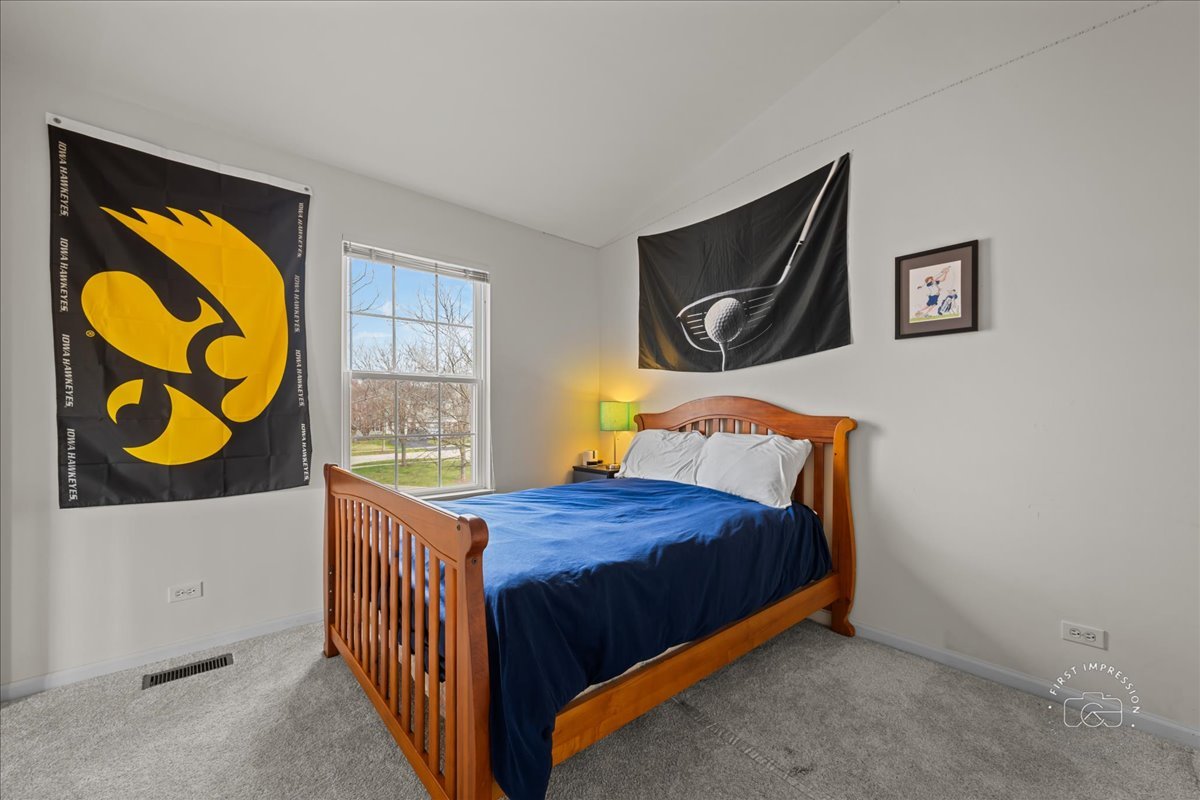 263 Lillian Court Geneva, IL 60134 - Photo 19 of 27 a bedroom with a bed and wall painting