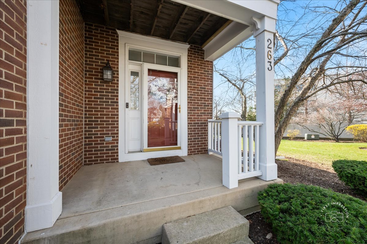263 Lillian Court Geneva, IL 60134 - Photo 2 of 27 a view of a porch with a door and wooden fence