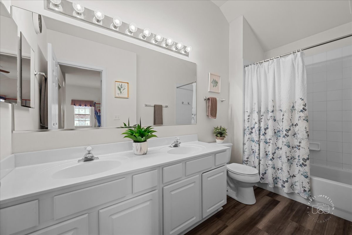 263 Lillian Court Geneva, IL 60134 - Photo 23 of 27 a spacious bathroom with double sink a toilet a window and shower