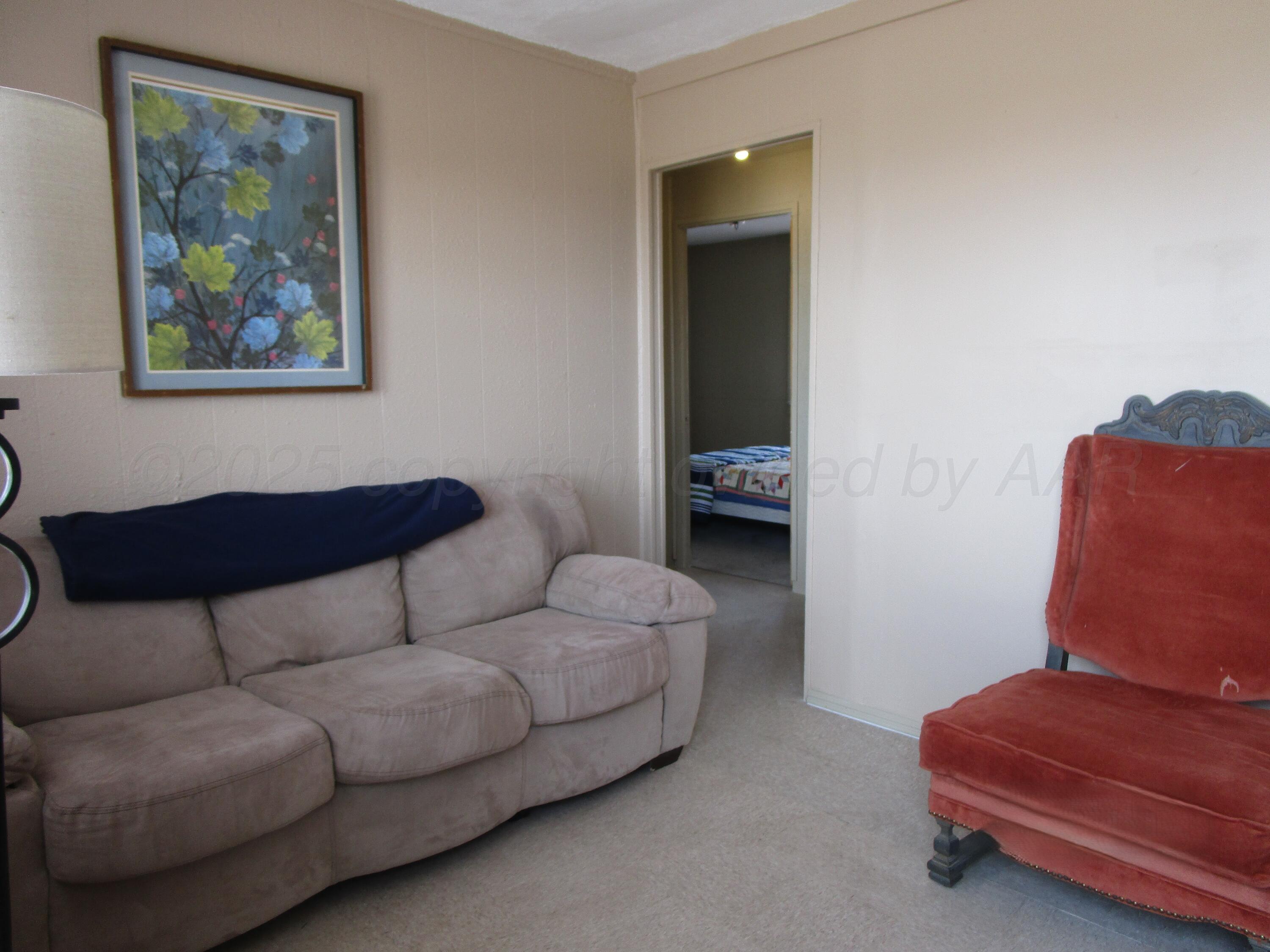 607 West Wilson Street, Unit 7 Borger, TX 79007 - Photo 3 of 8 a living room with furniture and a window