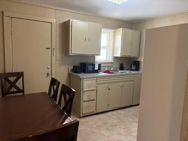 a kitchen with a stove and a refrigerator