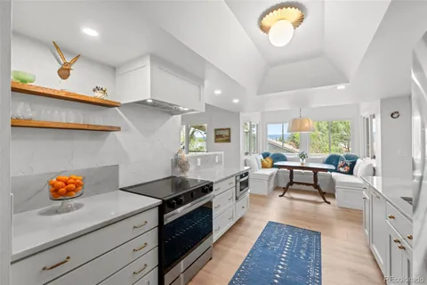 a kitchen with stainless steel appliances granite countertop a stove a sink and a refrigerator