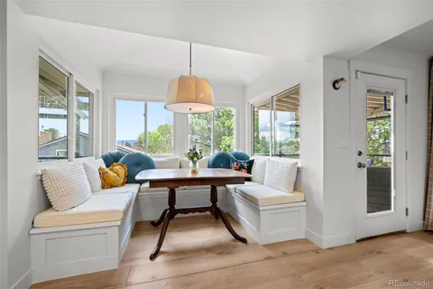 a living room with furniture a chandelier and a window