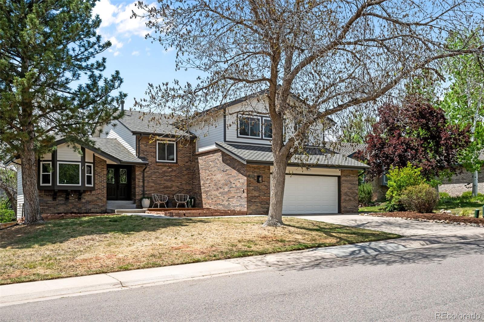 755 Old Stone Drive Highlands Ranch, CO 80126 - Photo 2 of 44 a front view of a house with a yard and garage
