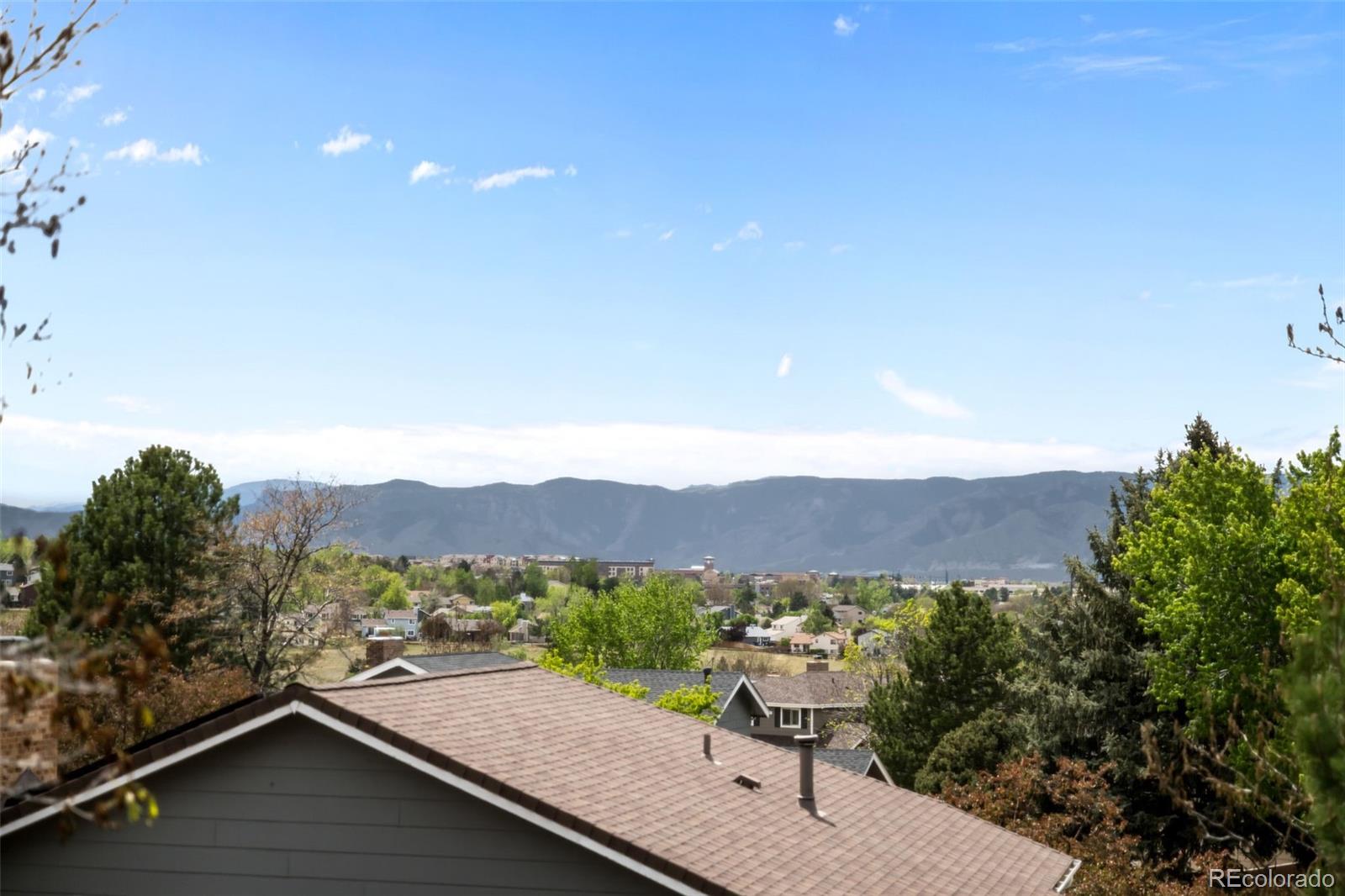 755 Old Stone Drive Highlands Ranch, CO 80126 - Photo 21 of 44 a view of a terrace with a garden and mountain view