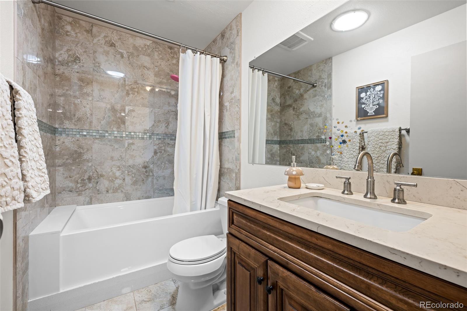 755 Old Stone Drive Highlands Ranch, CO 80126 - Photo 27 of 44 a bathroom with a sink a toilet and a bathtub