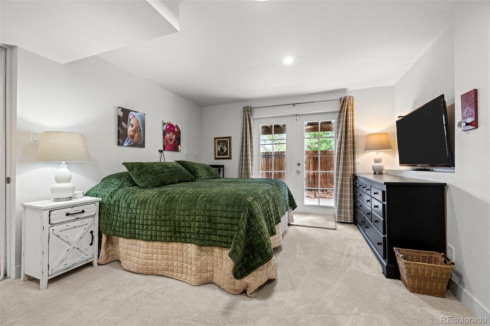 755 Old Stone Drive Highlands Ranch, CO 80126 - Photo 37 of 44 a bedroom with a large bed and a flat screen tv