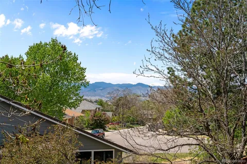 a view of a house with a tree in front of it