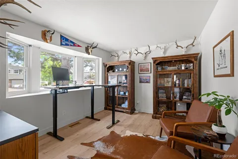 a living room with furniture large window and flat screen tv