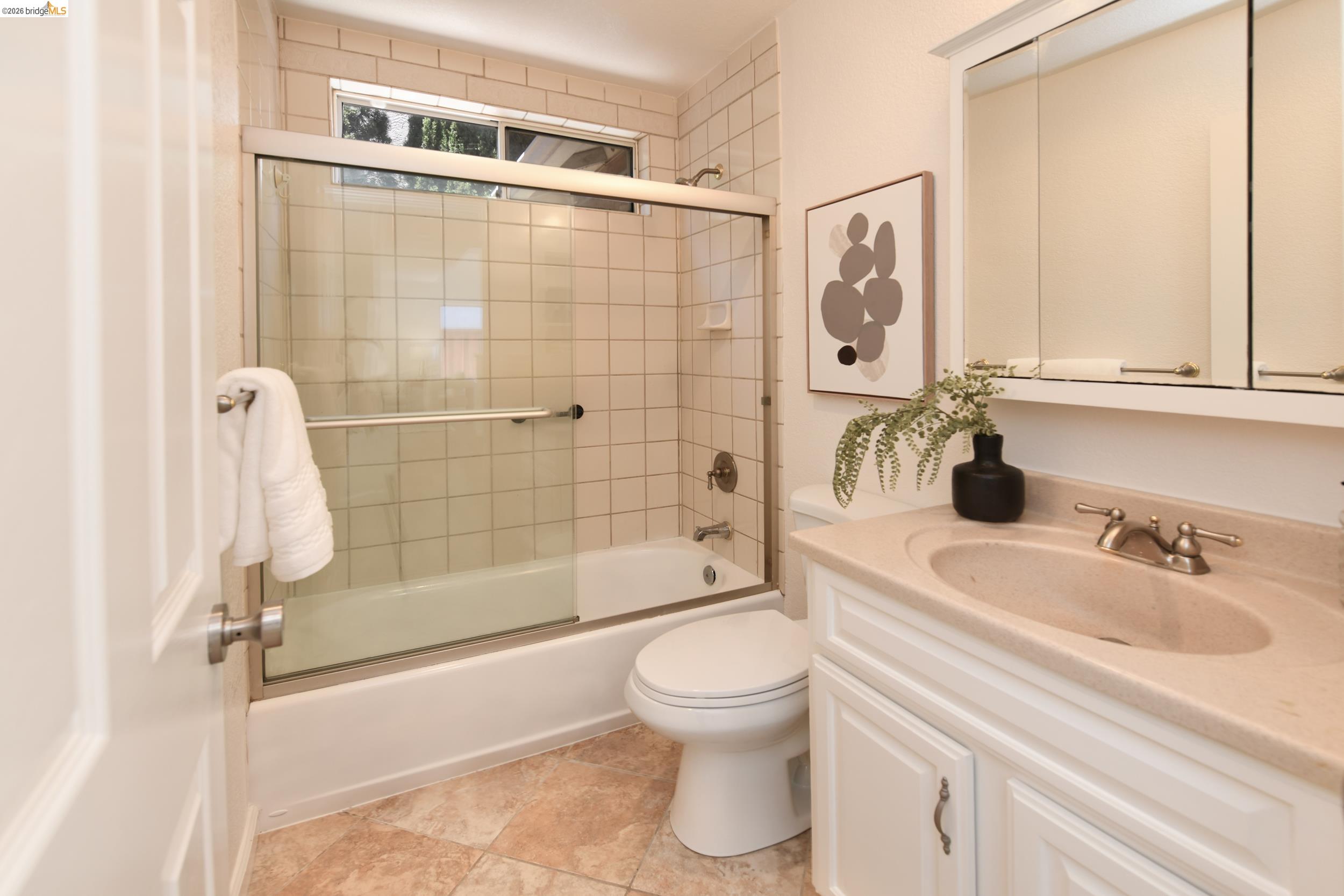 512 Burdick Drive Bay Point, CA 94565 - Photo 33 of 50 Bathroom featuring a white vanity with an integrated sink, brushed nickel faucet, and paneled cabinetry