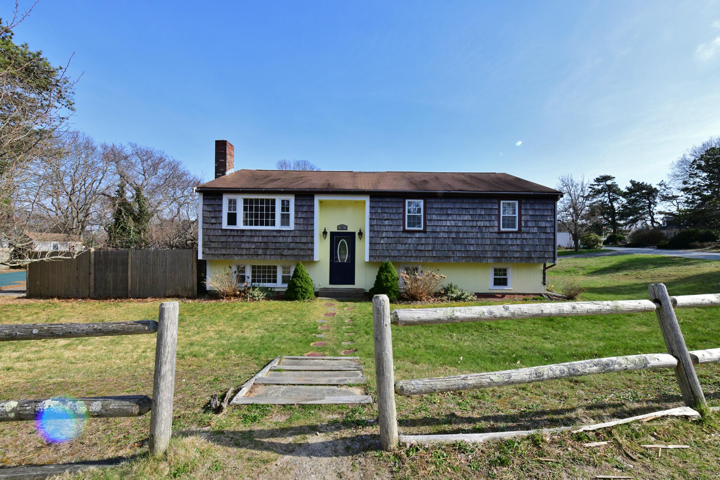 65 Siasconset Drive Sagamore Beach, MA 02562 - Photo 13 of 53 a front view of a house with a yard