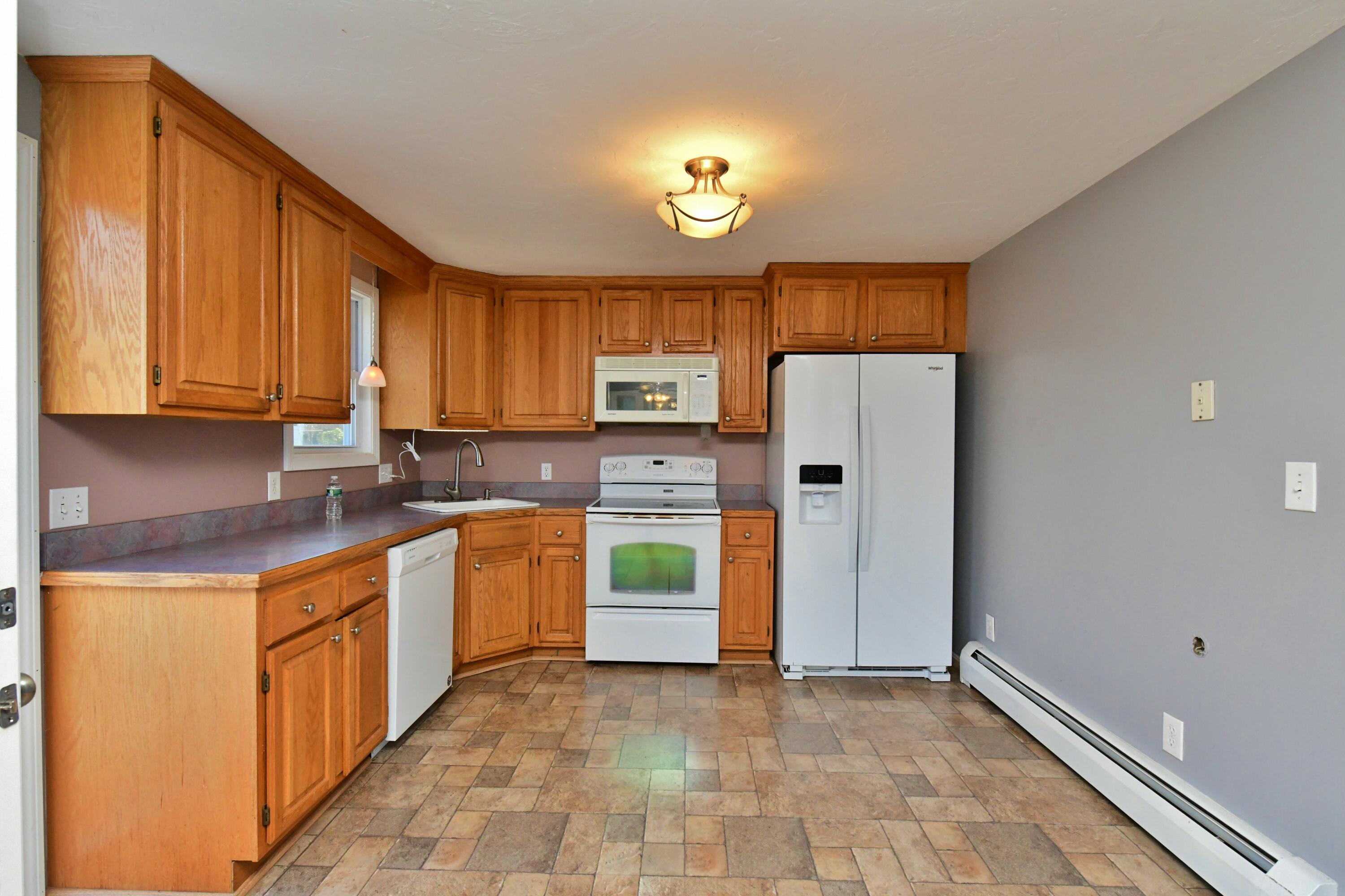65 Siasconset Drive Sagamore Beach, MA 02562 - Photo 17 of 53 a kitchen with stainless steel appliances granite countertop a refrigerator and a stove top oven