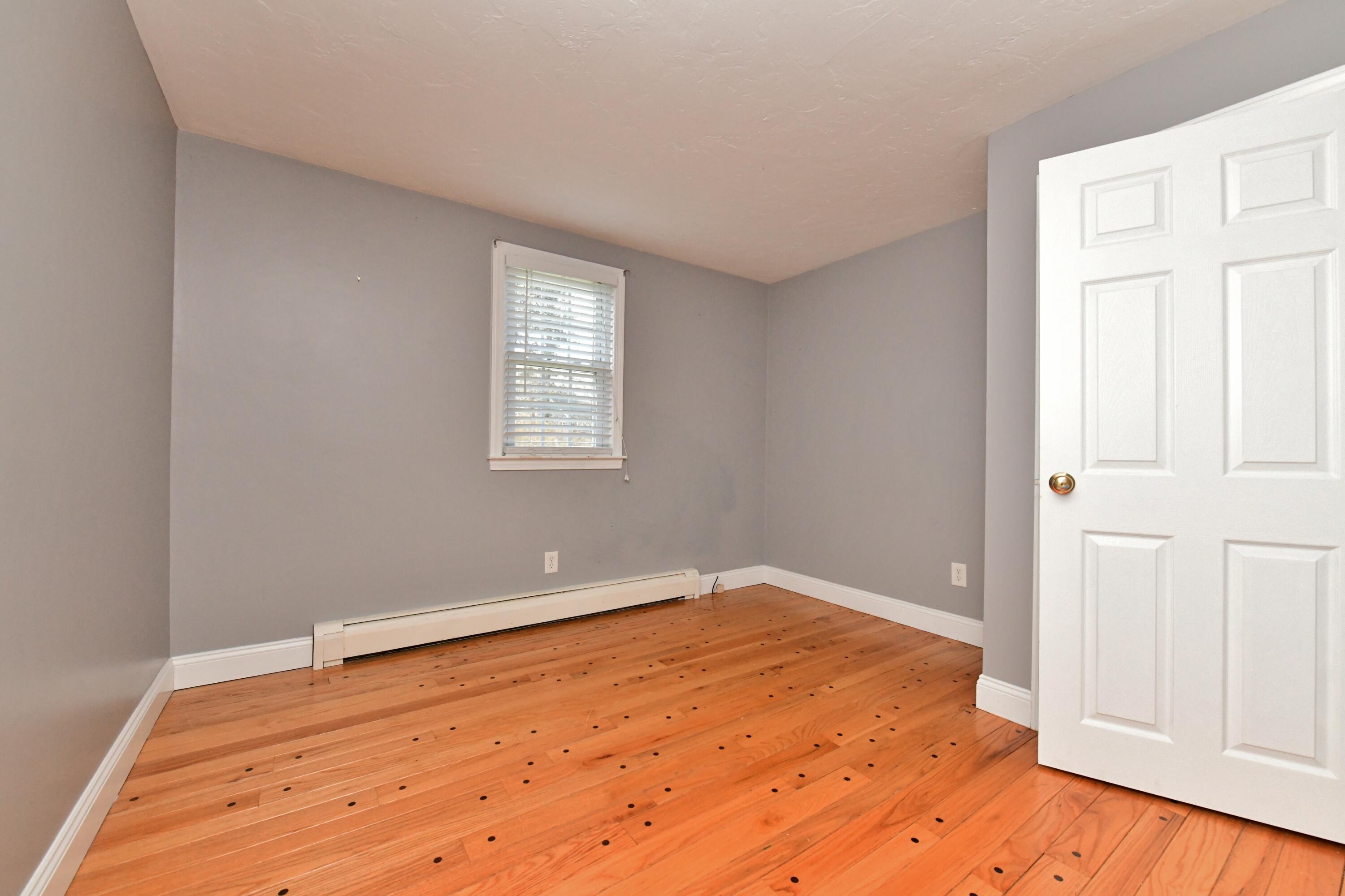 65 Siasconset Drive Sagamore Beach, MA 02562 - Photo 26 of 53 an empty room with wooden floor and windows