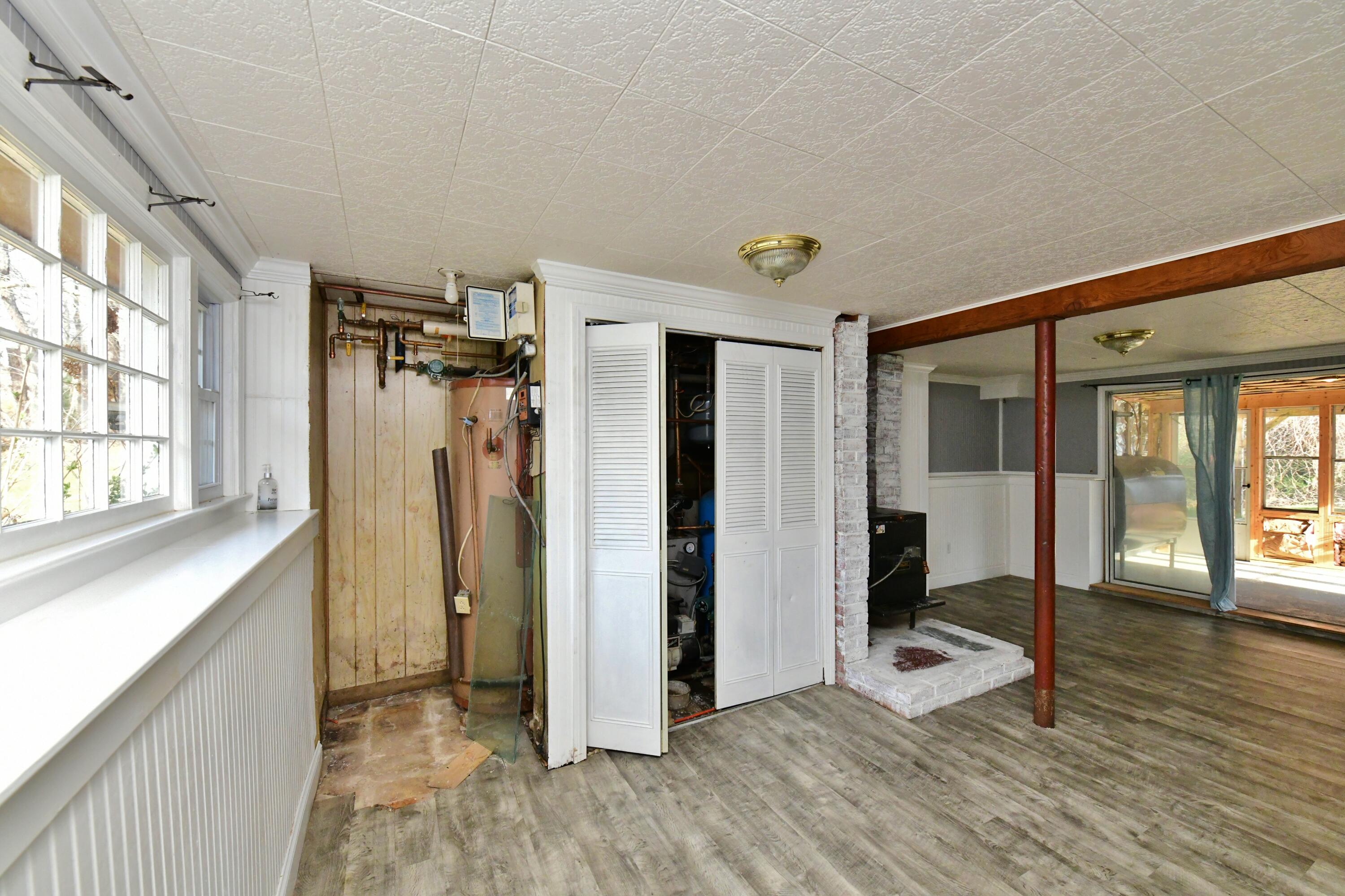 65 Siasconset Drive Sagamore Beach, MA 02562 - Photo 31 of 53 a view of a hallway with wooden floor and a living room