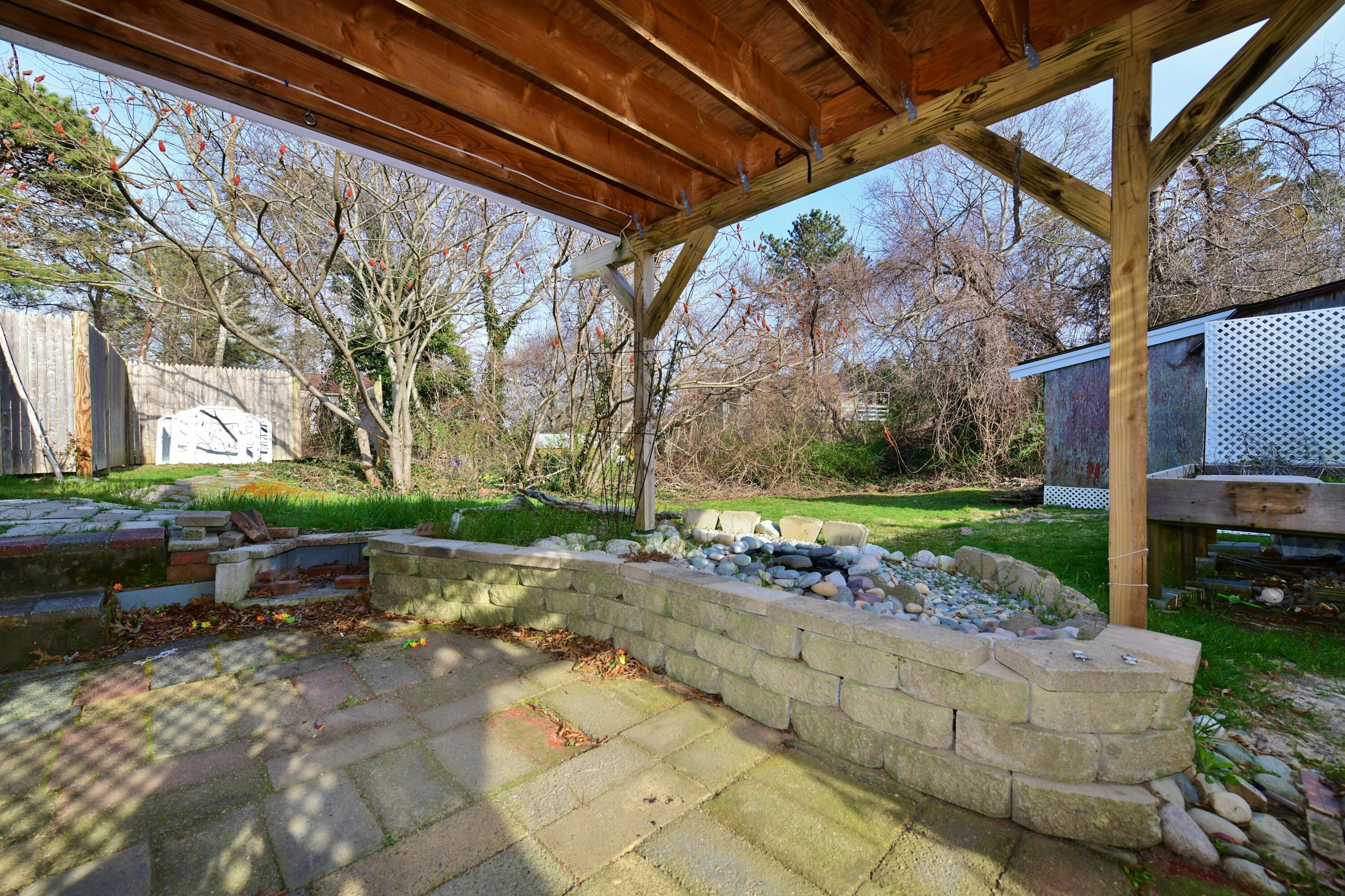 65 Siasconset Drive Sagamore Beach, MA 02562 - Photo 35 of 53 a view of backyard with outdoor seating and plants
