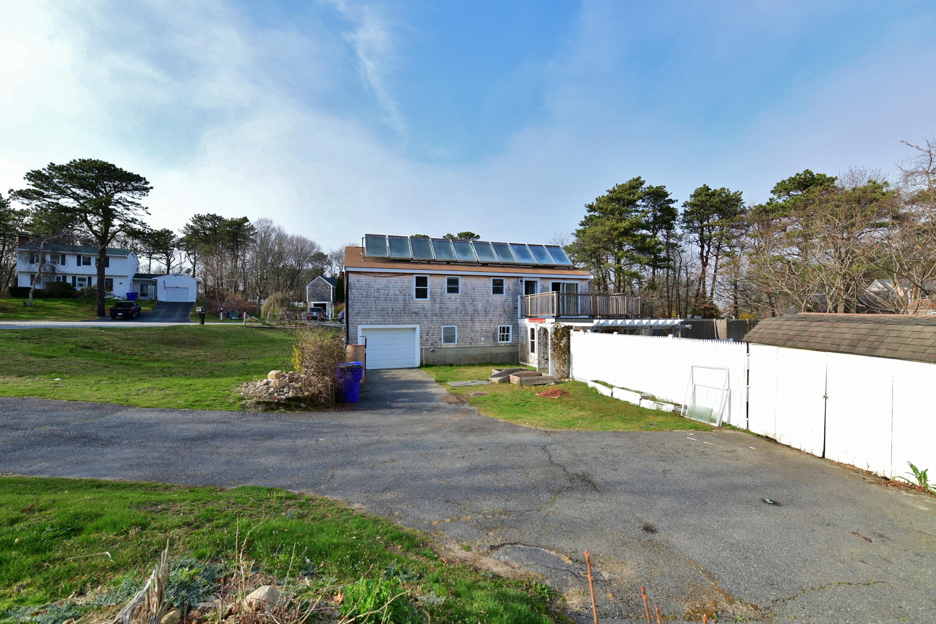 65 Siasconset Drive Sagamore Beach, MA 02562 - Photo 41 of 53 a view of a house with a yard