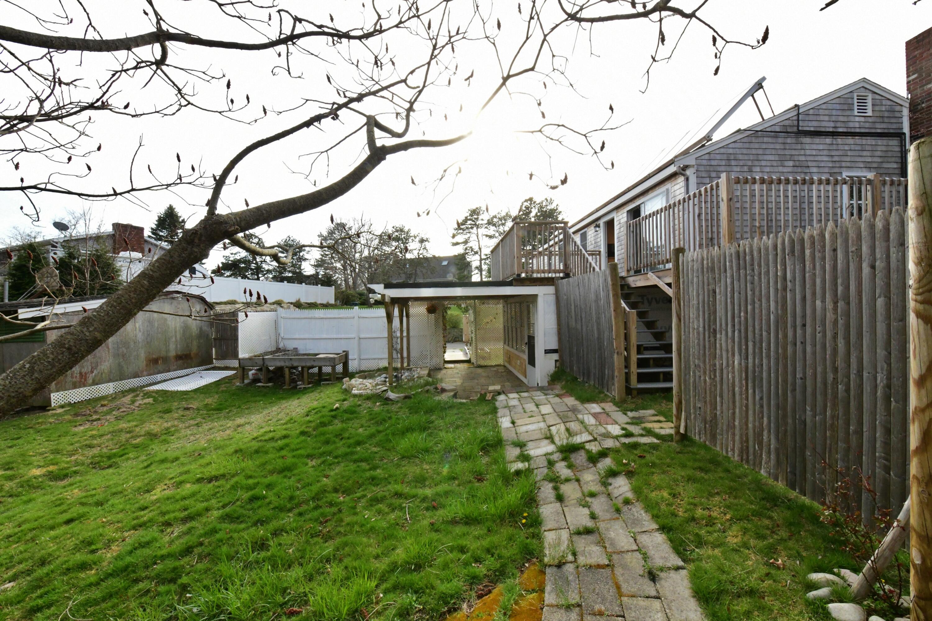 65 Siasconset Drive Sagamore Beach, MA 02562 - Photo 43 of 53 a backyard of a house with lots of green space