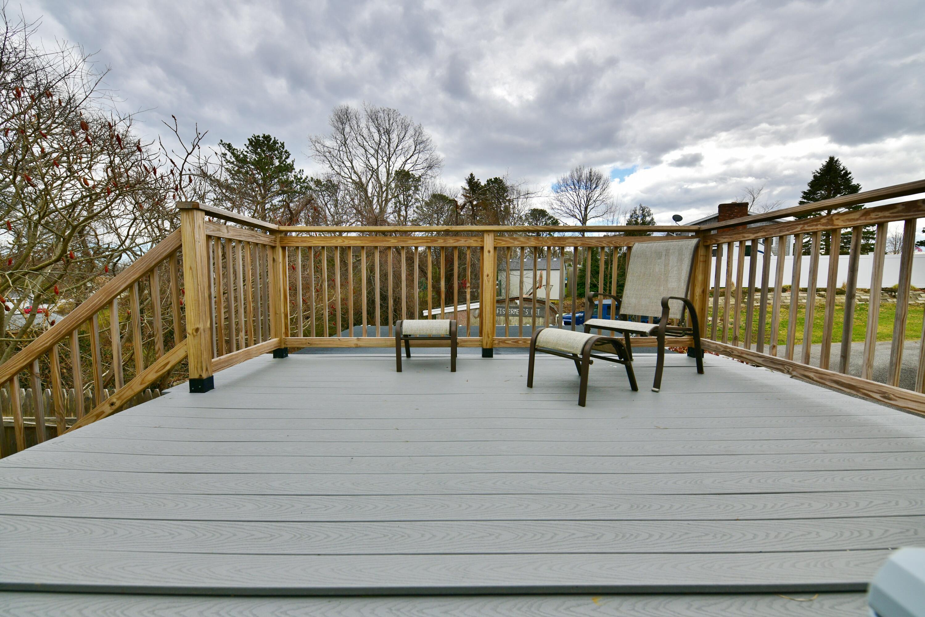 65 Siasconset Drive Sagamore Beach, MA 02562 - Photo 6 of 53 a lawn chairs sitting on deck with a yard