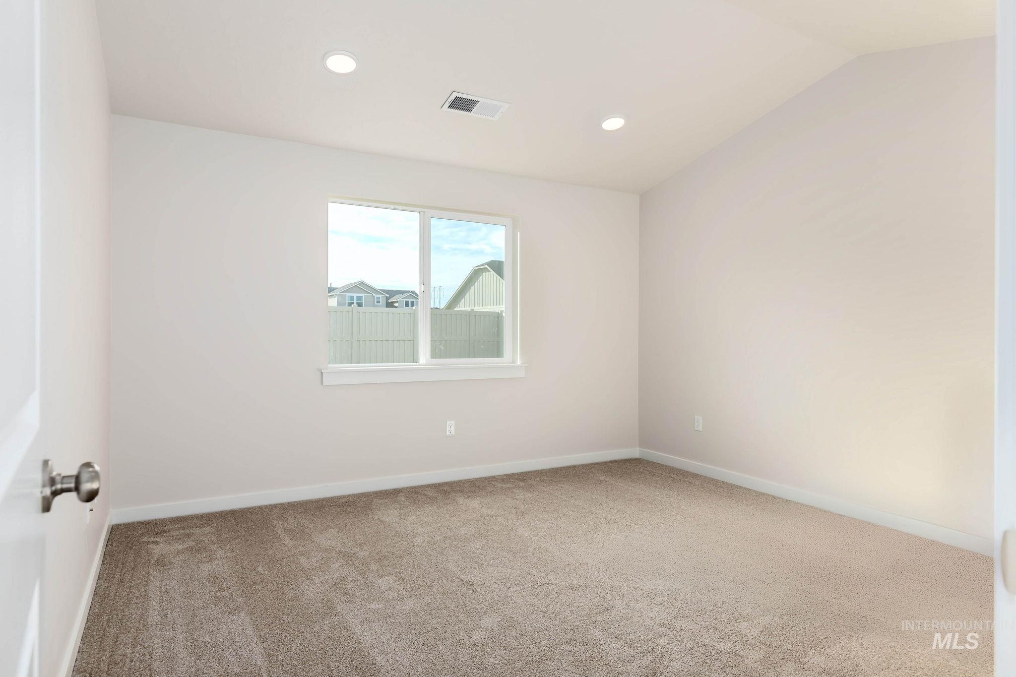 11363 Bluefield Drive Caldwell, ID 83605 - Photo 13 of 35 Carpeted empty room with recessed lighting and vaulted ceiling