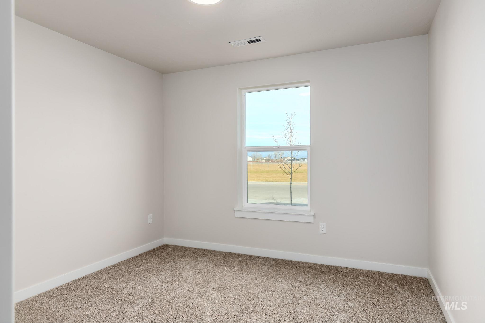 11363 Bluefield Drive Caldwell, ID 83605 - Photo 21 of 35 Carpeted empty room with baseboards