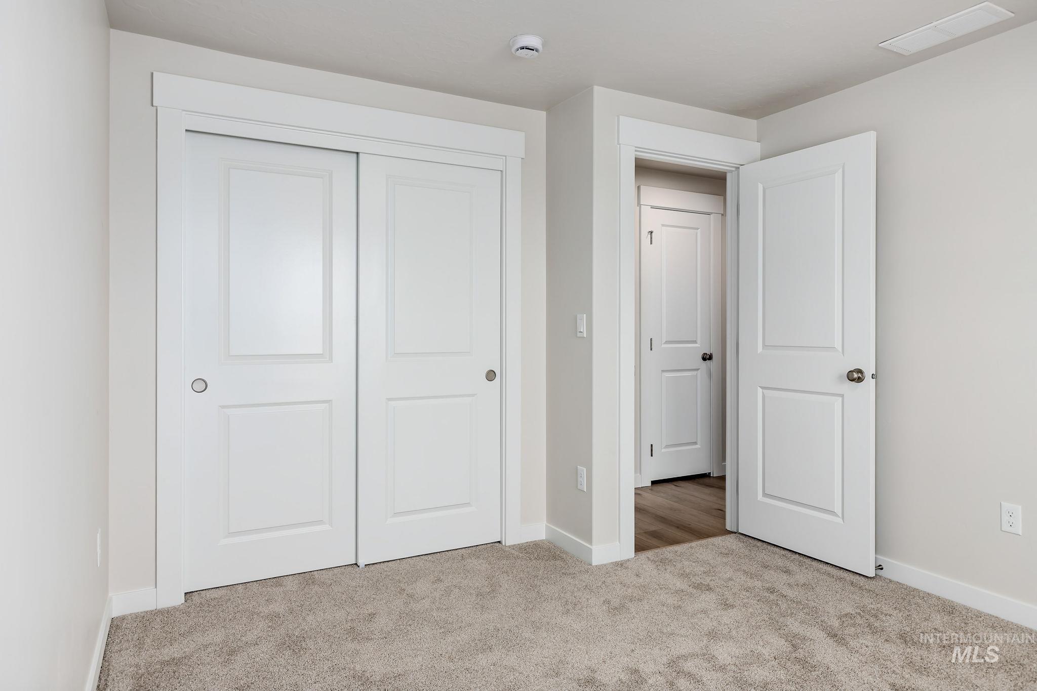 11363 Bluefield Drive Caldwell, ID 83605 - Photo 24 of 35 Unfurnished bedroom featuring light colored carpet and a closet