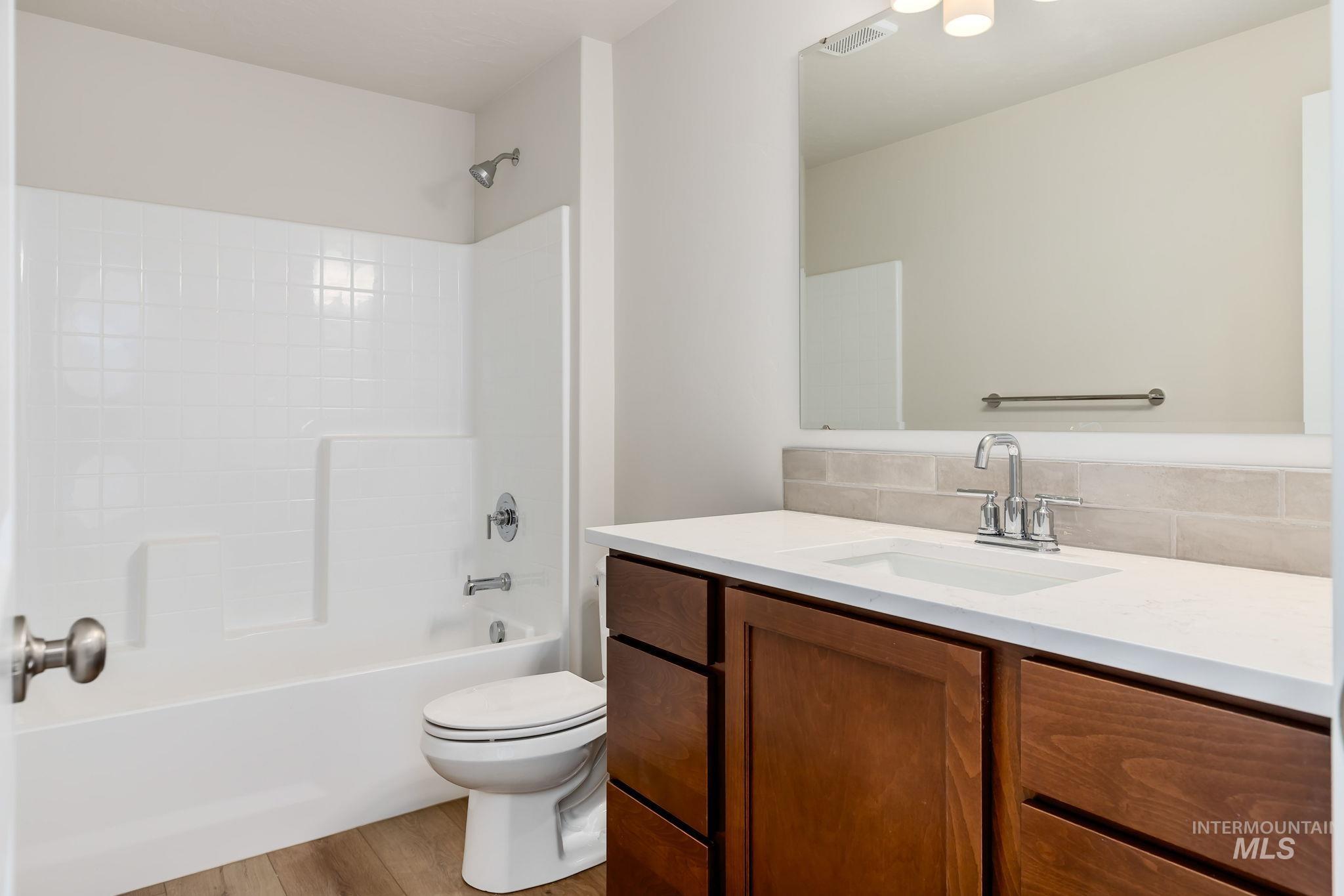 11363 Bluefield Drive Caldwell, ID 83605 - Photo 25 of 35 Bathroom featuring vanity, shower / bath combination, and light wood finished floors