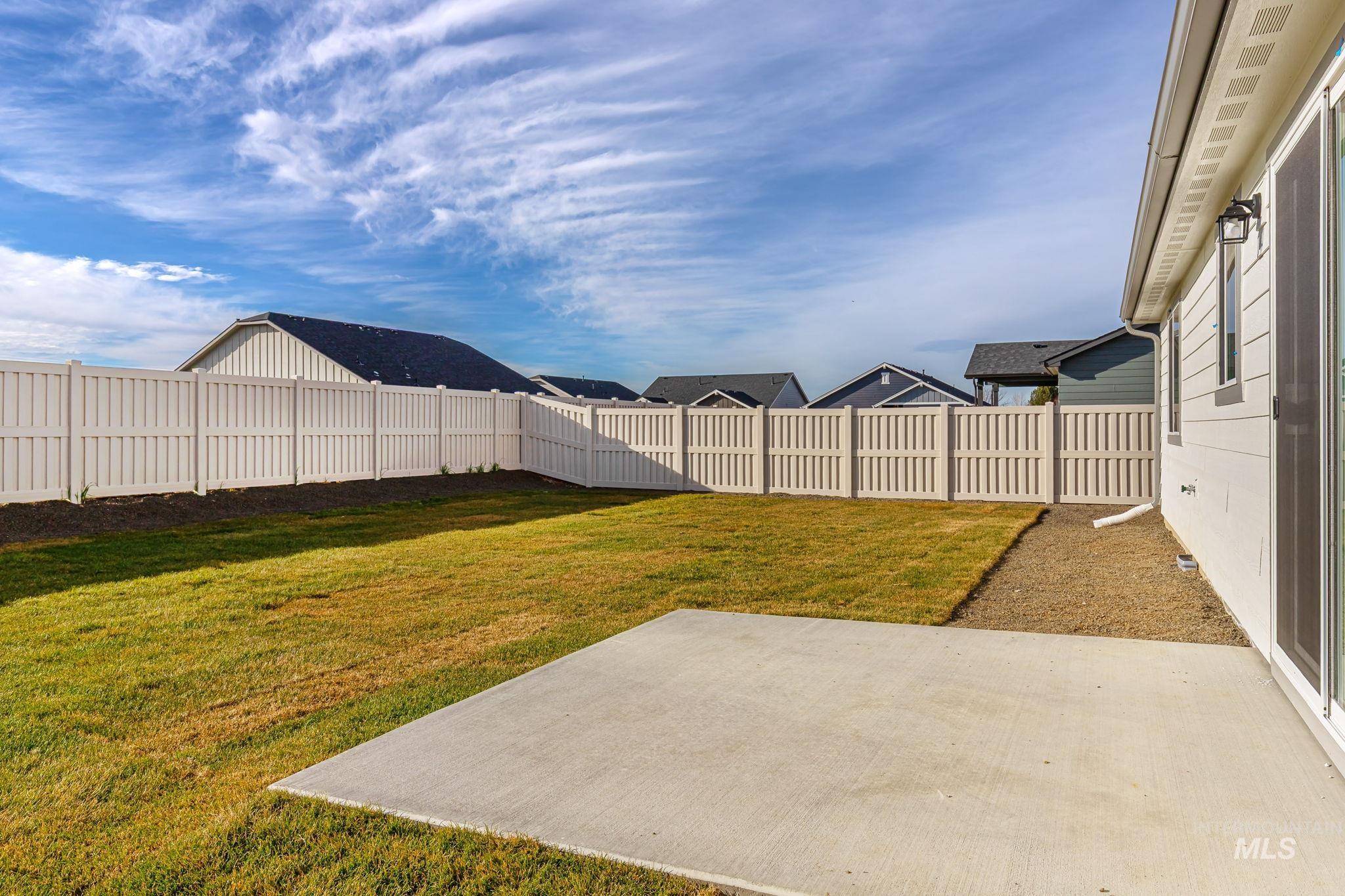 11363 Bluefield Drive Caldwell, ID 83605 - Photo 27 of 35 Fenced backyard with a patio area and a residential view