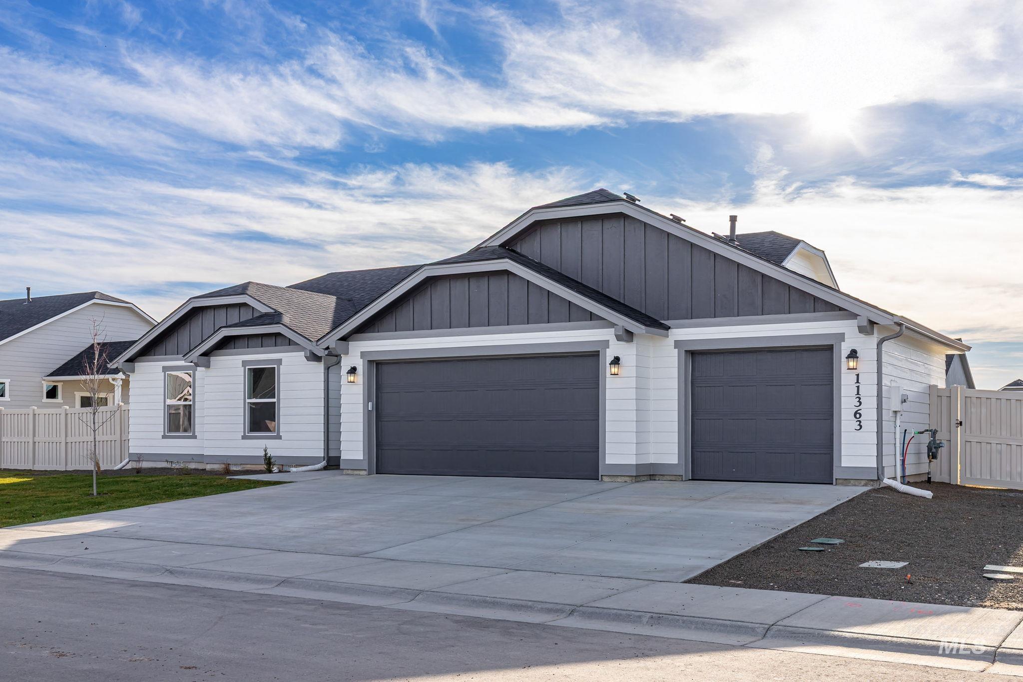 11363 Bluefield Drive Caldwell, ID 83605 - Photo 3 of 35 View of front of home featuring board and batten siding, driveway, an attached garage, and roof with shingles