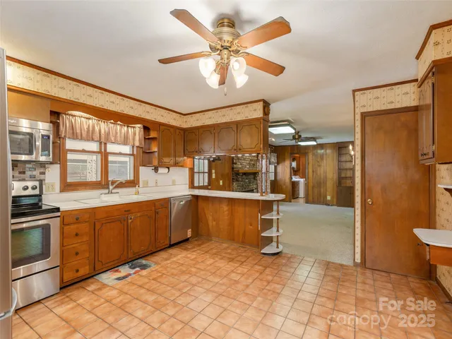 a large white kitchen with a large window