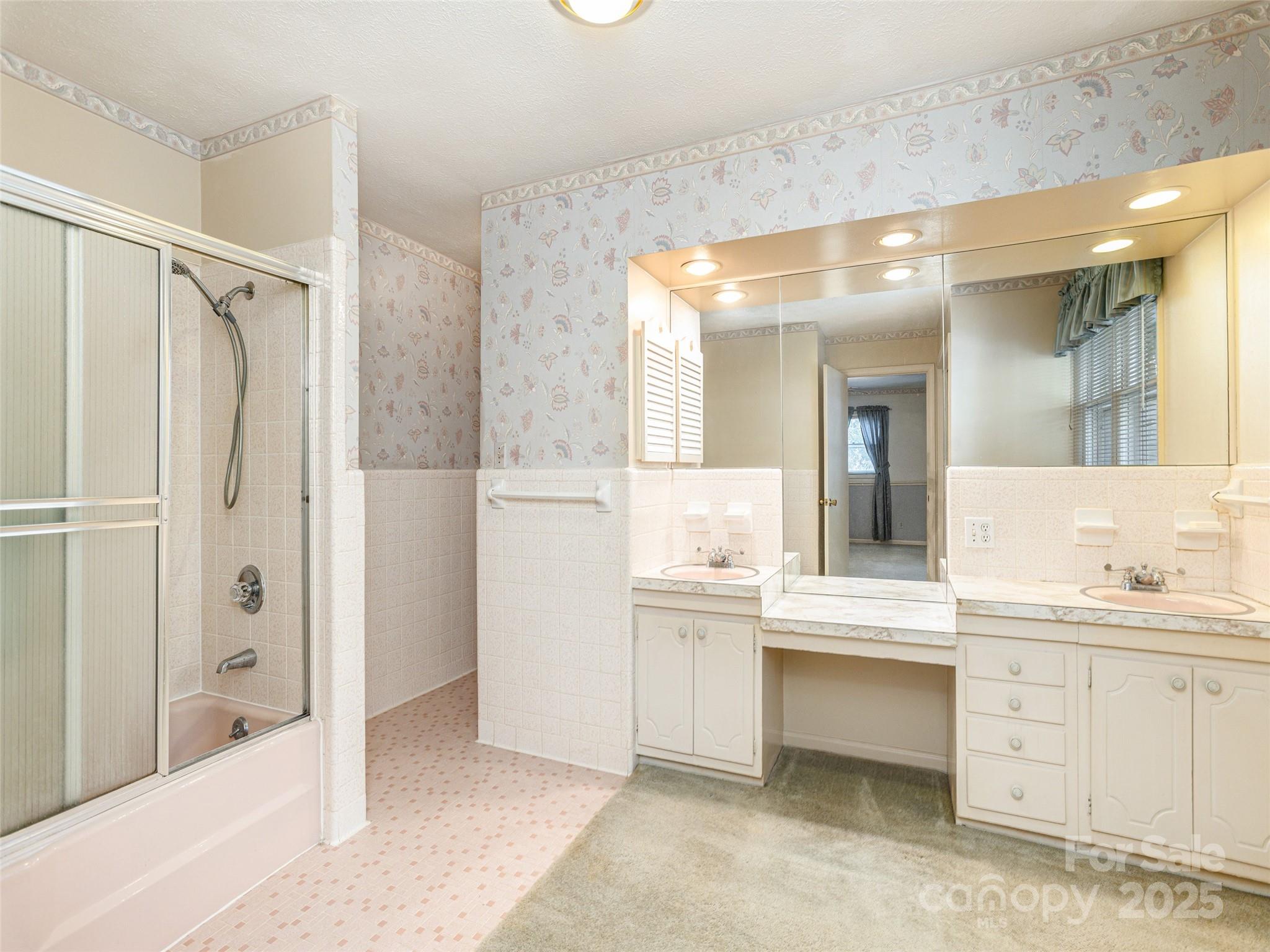 2640 Haywood Road Hendersonville, NC 28791 - Photo 18 of 41 a bathroom with a double vanity sink mirror and bathtub