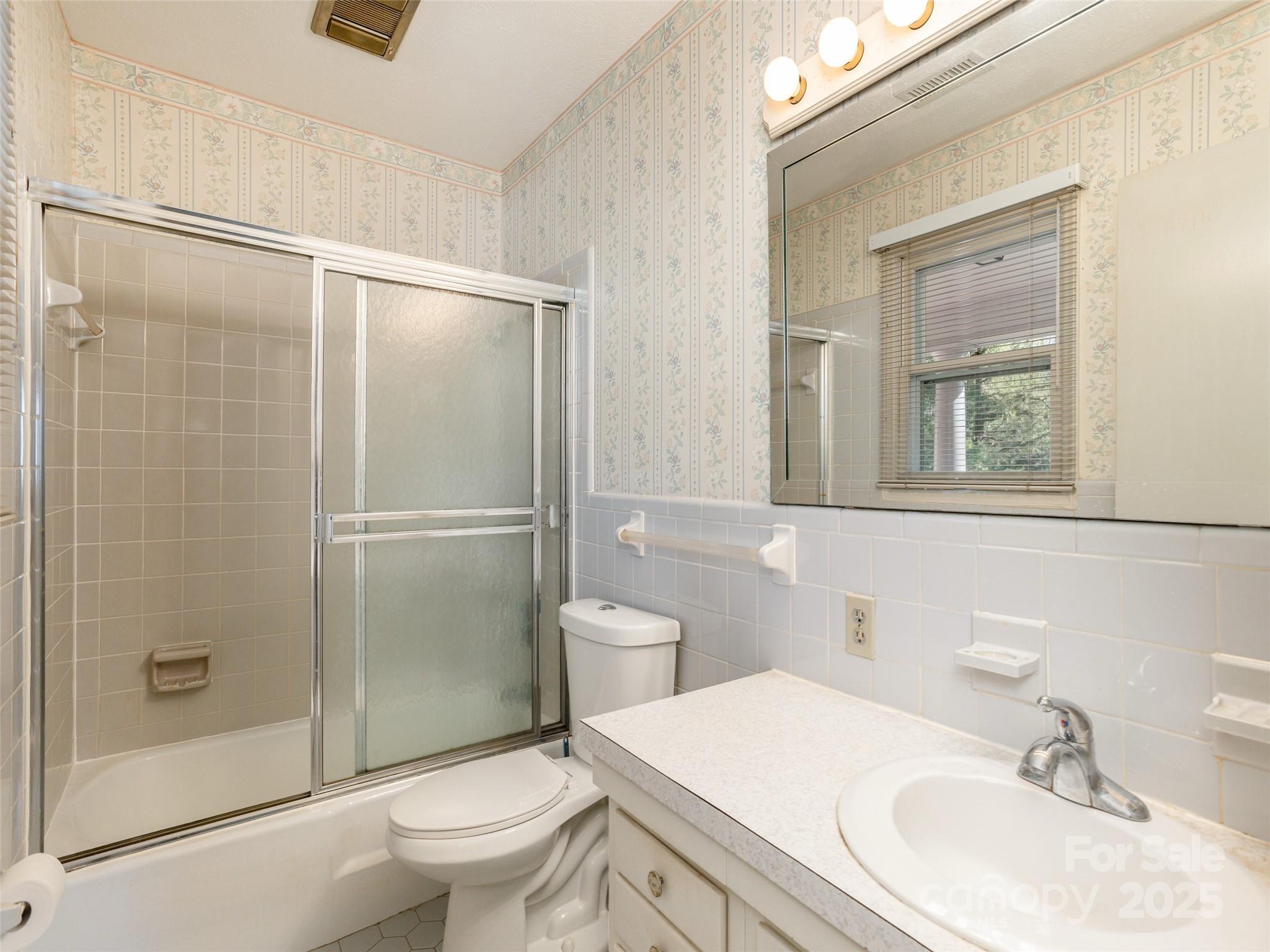 2640 Haywood Road Hendersonville, NC 28791 - Photo 21 of 41 a bathroom with a granite countertop sink toilet and shower