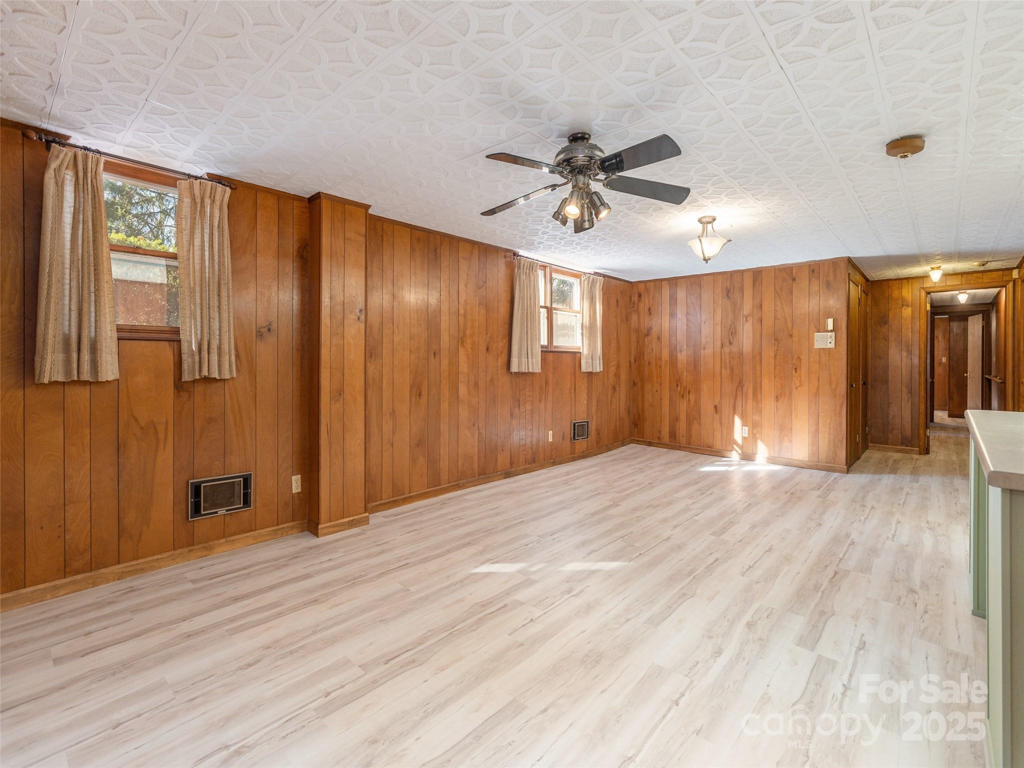 2640 Haywood Road Hendersonville, NC 28791 - Photo 26 of 41 a view of empty room with wooden floor and fan