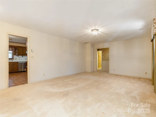 a view of empty room with a fireplace