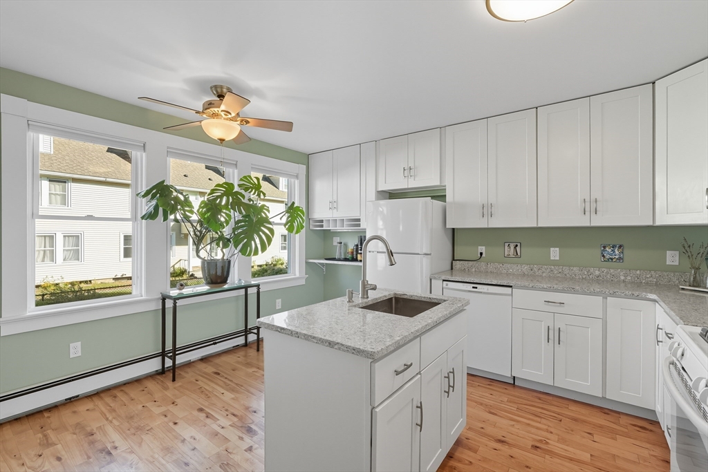 5 Grant Street, Unit 5 Easthampton, MA 01027 - Photo 14 of 36 a kitchen with stainless steel appliances granite countertop a stove a sink and a refrigerator