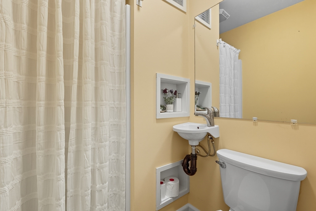 5 Grant Street, Unit 5 Easthampton, MA 01027 - Photo 16 of 36 a bathroom with a sink a toilet and shower curtain
